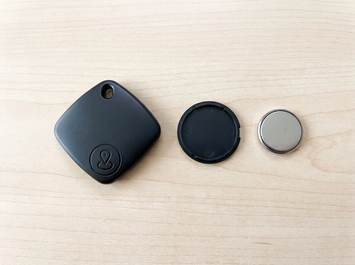 iTagPro with its back cover and coin cell