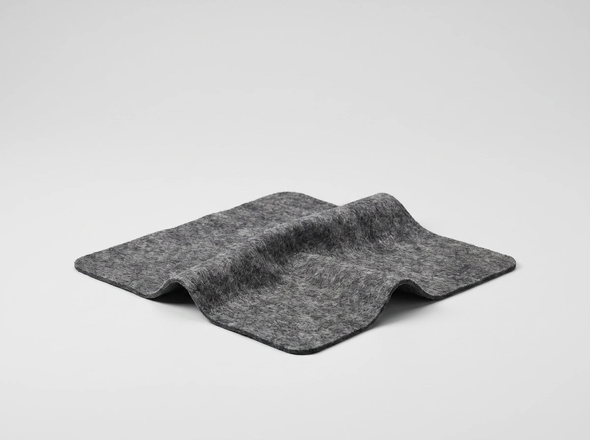 NanoPolix Nano Sparkle Cloth, a gray square cloth with rounded corners, lying in a soft fold on a light gray background