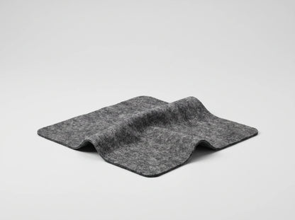 NanoPolix Nano Sparkle Cloth, a gray square cloth with rounded corners, lying in a soft fold on a light gray background
